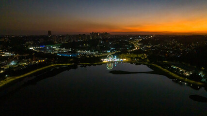 Curitiba in Paraná, Brazil. Aerial View. Wonderful sunset with views of buildings and Tanguá Park. Lake with reflection..