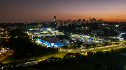 Curitiba in Paraná, Brazil. Aerial View. Wonderful sunset with views of buildings and Tanguá Park. Lake with reflection..