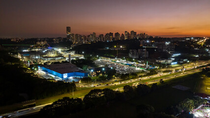 Curitiba in Paraná, Brazil. Aerial View. Wonderful sunset with views of buildings and Tanguá Park. Lake with reflection..