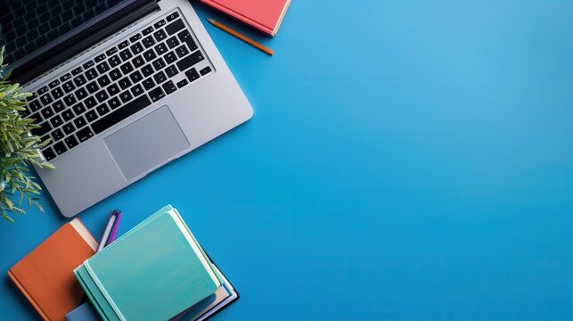 A laptop and textbooks are placed on a blue desk, symbolizing the combination of traditional and digital learning methods. Generative AI