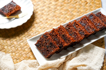 Kek Buah Kukus, a traditional Malaysian steamed fruit cake filled with dried fruits, nuts, and spices, enjoyed during celebrations.