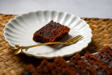 Kek Buah Kukus, a traditional Malaysian steamed fruit cake filled with dried fruits, nuts, and spices, enjoyed during celebrations.