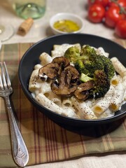 Front facing shot of chicken, rigatoni  with vegetables