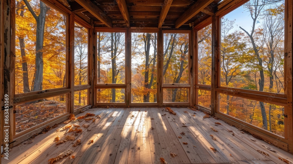 Poster a large open room with a view of trees and leaves. the room is empty and has a lot of natural light 