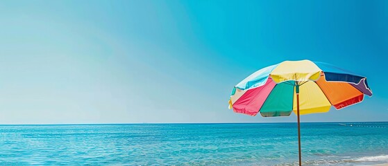 Stunning ocean view from under a colorful beach umbrella, creating a relaxing summer vacation scene