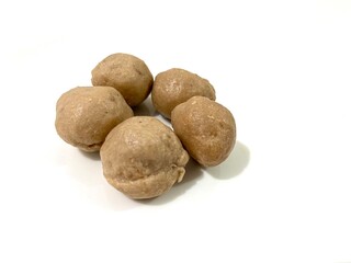 Several whole uncooked Indonesian Bakso Sapi or beef meatballs isolated on white background