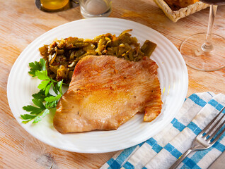 Fried Iberian pig served with beans and parsley