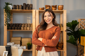 Portrait of Asian young woman pack order into box and look at camera. 