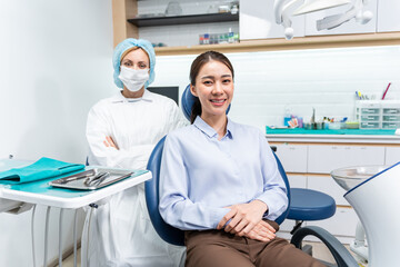 Portrait of Asian young woman patient and dentist at health care clinic. 