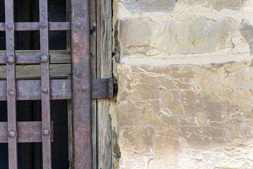 old stone wall with window grille, detail