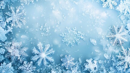 Winter background with ice snowflakes in blue tones and copy space surrounded by real icy crystals for festive touch