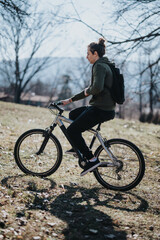 Fototapeta premium A relaxed man rides his bicycle through a sunlit park, enjoying the peaceful outdoor setting and fresh air.