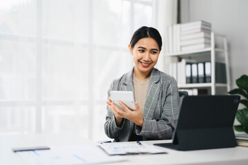Confident Asian Business Woman Working on Tablet and Laptop in Modern Office Environment