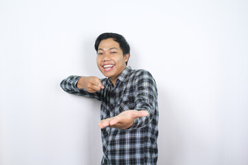 happy asian man excited to pointing finger to empty palm raised toward camera isolated