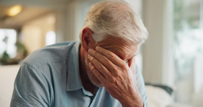 Home, sofa and elderly man with headache for stress, anxiety and worry of retirement plan. Senior person, frustrated and fatigue with eye pain in living room for health problem, vertigo and brain fog
