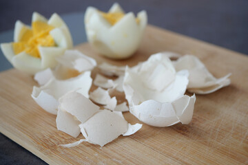 Broken egg shell on wooden cutting board, 