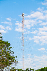 Radio network telecommunication broadcast tower background over blue cloudy sky