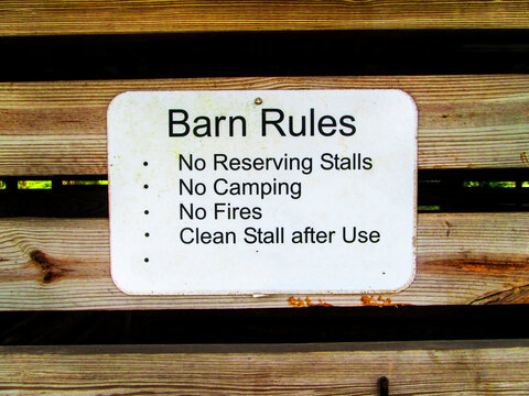 Barn Rules Metal Sign On Wood Slabs In  A Horse Stable