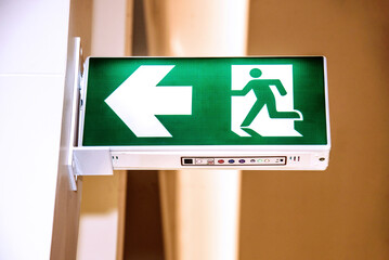 Arrow signs indicate fire escape routes in buildings