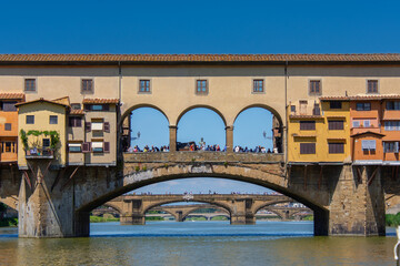 View of the famous Ponte Vecchio over the Arno river in the city of Florence in Italy.