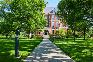 Traditional Huntington Campus Building Amidst Greenery Eye-Level Pathway View