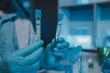 A scientist uses laboratory equipment for a research experiment, test tube is essential for chemists to use in experiments, scientific researchers must concentrate on testing samples in the lab