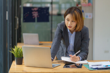 Asian businesswoman working with a laptop at the office.