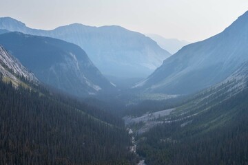 Obraz premium Dramatic landscapes in the Canadian Rocky Mountains with fog on the background of high mountain lakes