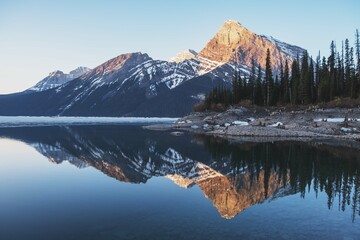 Dramatic landscapes in the Canadian Rocky Mountains with fog on the background of high mountain lakes