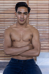 Handsome, attractive and good looking shirtless topless south asian male model with a gym fit body and well defined sixpacks and abs as well as good biceps