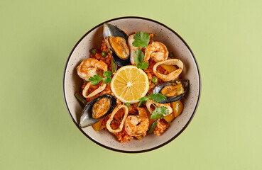 Delicious Seafood Fried Rice with Lemon Garnish on Green Background