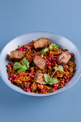 Title Minimalist Beef and Pomegranate Pilaf Against Blue Background