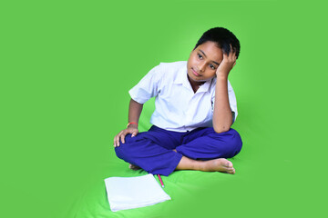 Obraz premium Unhappy sad tired caucasian little child sits at Ground presses hands to head, suffers from tension . Problems in study, education at school and home remotely