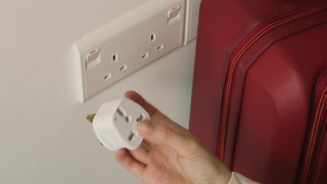 The UK or SG 3 Pin Plug Power converter or travel adapter. The electrical outlet socket in the hotel room