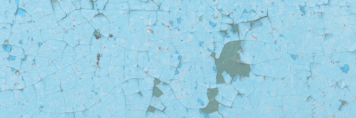 Blue peeling paint on the wall. Old concrete wall with cracked flaking paint. Weathered rough painted surface with patterns of cracks and peeling. High resolution texture for background and design.