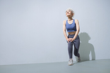 Full body with beautiful muscles of a healthy active senior (elderly) who is easy to use in sports, exercise, and health maintenance Background blue (light blue) Image of starting stretching