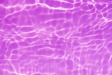 Purple water splashes on the surface ripple blur. Defocus blurred transparent pink colored clear calm water surface texture with splash and bubble. Water waves with shining pattern texture background