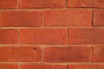 A closeup of a red brick wall in good light.