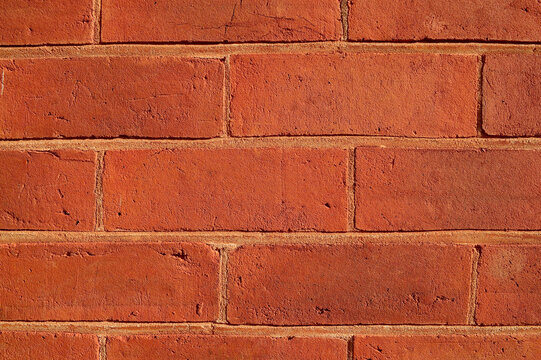 Fototapeta A closeup of a red brick wall in good light.