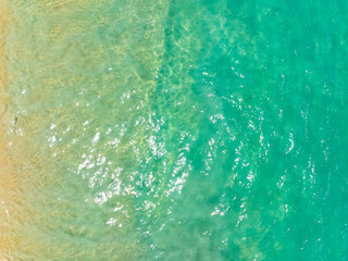 Aerial view of amazing sea surface water texture background,Sun reflections over ocean, Aerial flying drone view Waves water surface texture on sunny tropical ocean in Phuket island Thailand