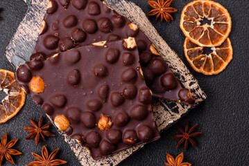 Black bitter chocolate with whole hazelnuts, candied fruits and mint