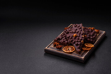 Black bitter chocolate with whole hazelnuts, candied fruits and mint