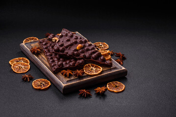 Black bitter chocolate with whole hazelnuts, candied fruits and mint