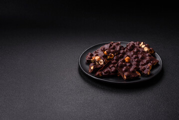 Black bitter chocolate with whole hazelnuts, candied fruits and mint