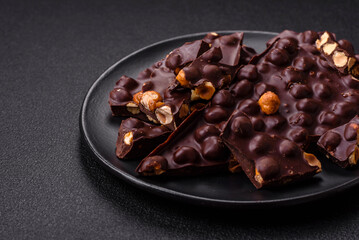 Black bitter chocolate with whole hazelnuts, candied fruits and mint