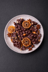 Black bitter chocolate with whole hazelnuts, candied fruits and mint
