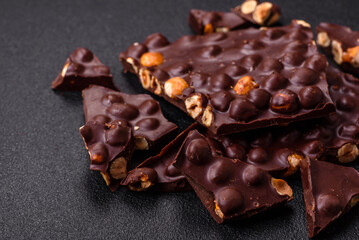 Black bitter chocolate with whole hazelnuts, candied fruits and mint