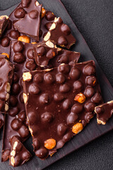Black bitter chocolate with whole hazelnuts, candied fruits and mint
