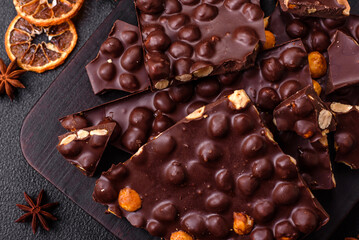 Black bitter chocolate with whole hazelnuts, candied fruits and mint