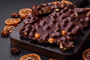 Black bitter chocolate with whole hazelnuts, candied fruits and mint